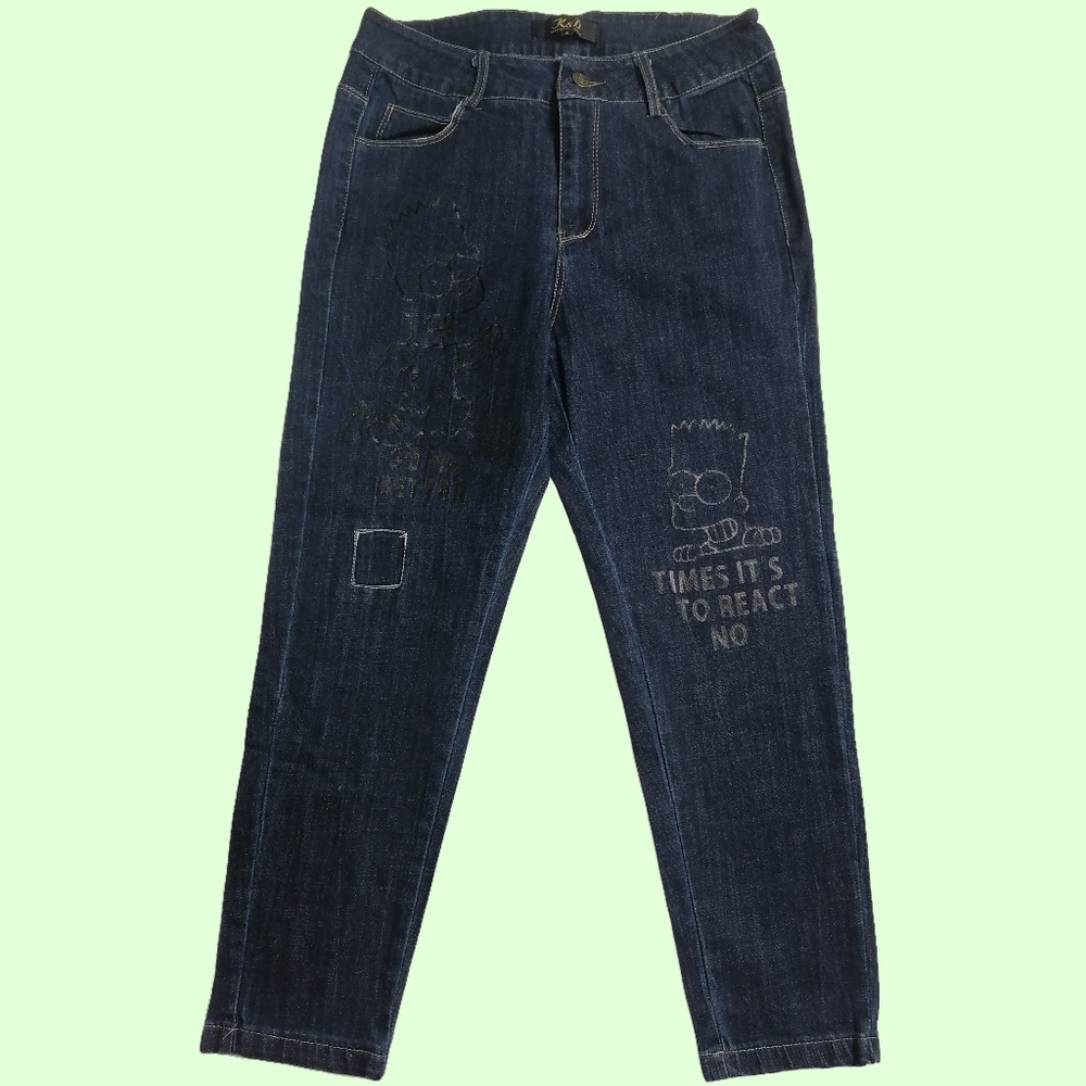 🦝 M,A pair of dark blue jeans with a distressed look and Bart Simpson graphics.